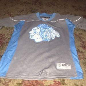 Lady’s blue and grey hawks jersey